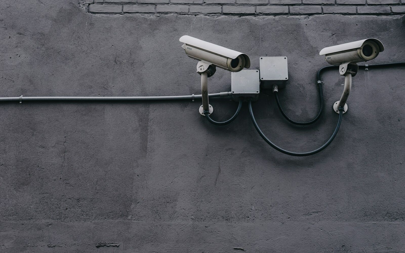Two bullet security cameras mounted on an exterior wall