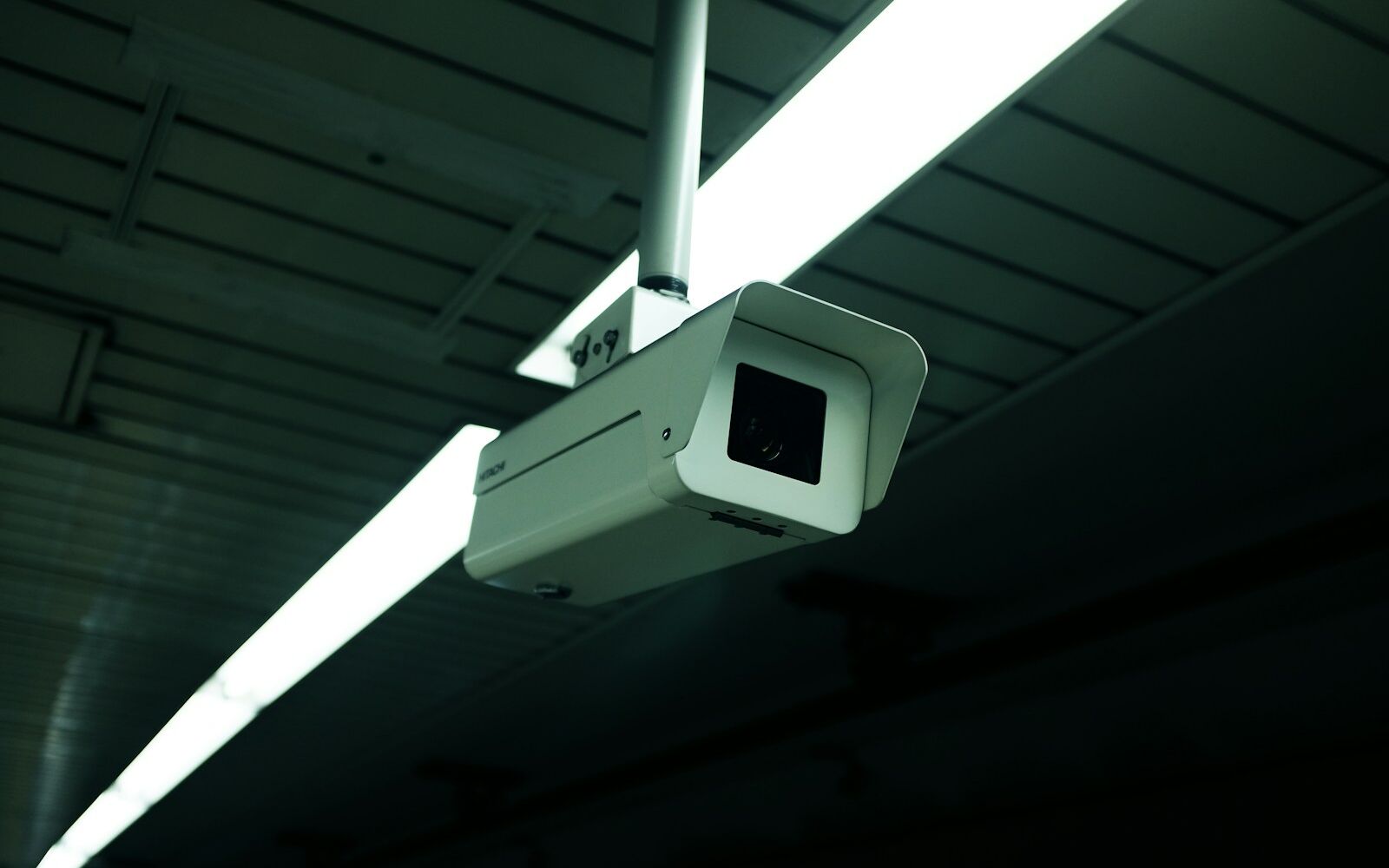 A security camera mounted from an indoor ceiling