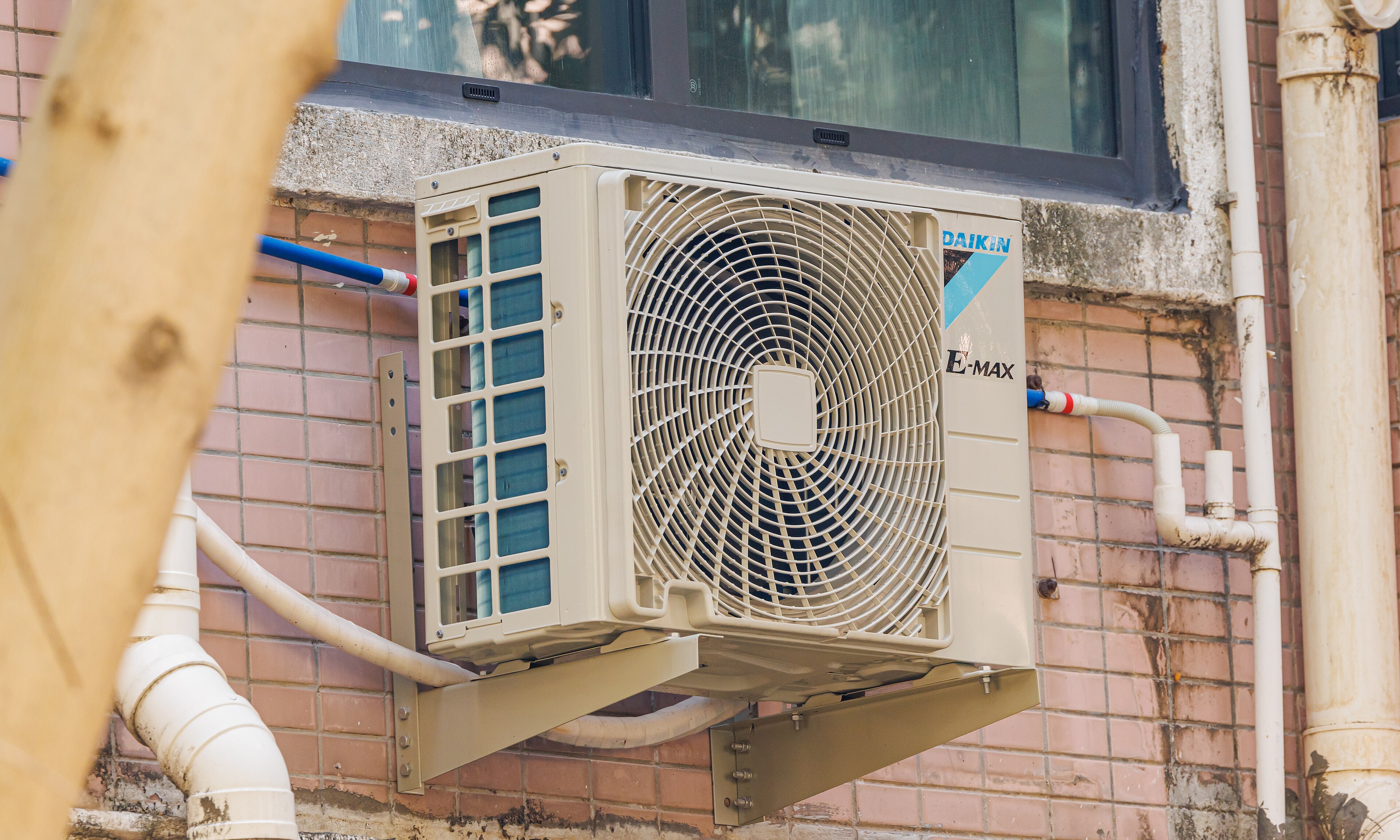 An outdoor air conditioning unit beside a building
