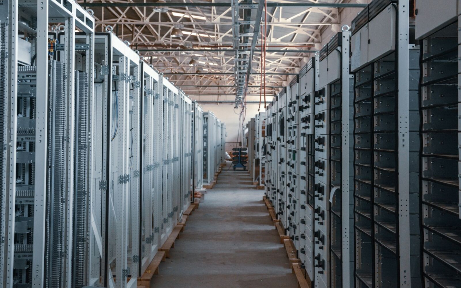 An aisle between rows of equipment racks in a server room